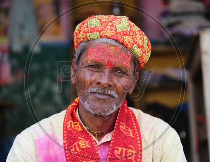 Old man with Colors on his face - Holi Celebrations - Indian Festival - Colors/Colorful at Nandagaon