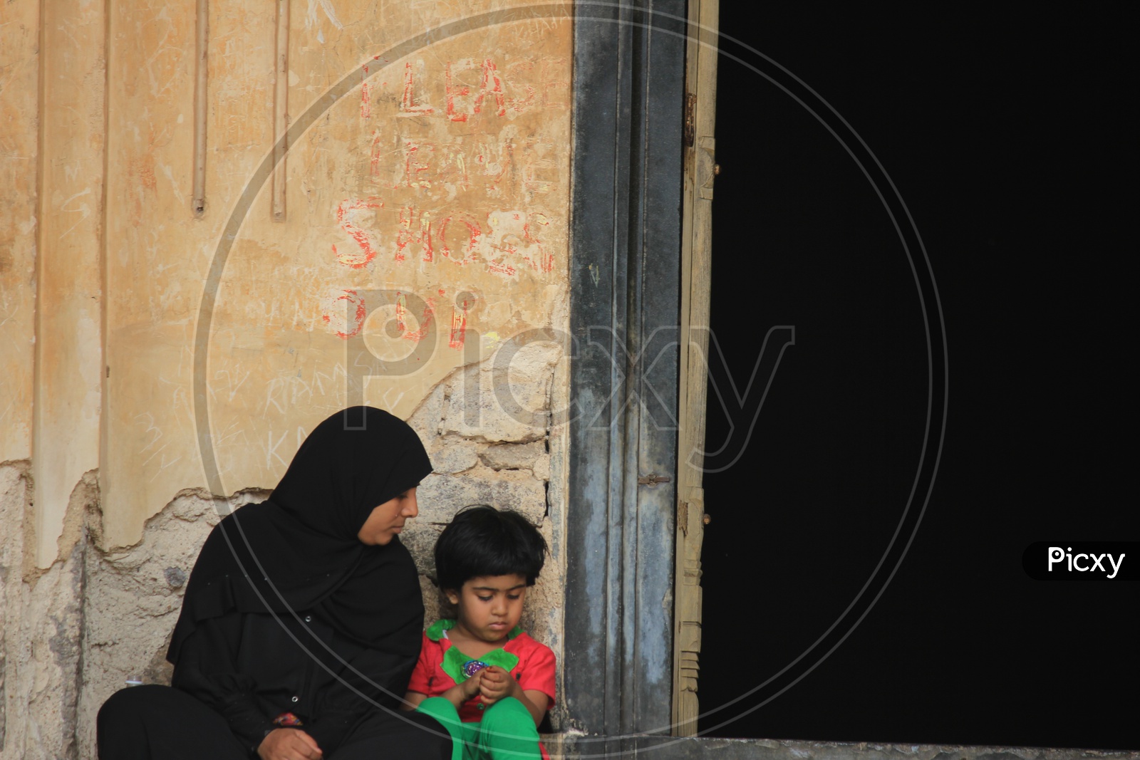 A Beautiful Composition Shot Of a Muslim Mother and Child At Which Mother Looking Her Child intensely