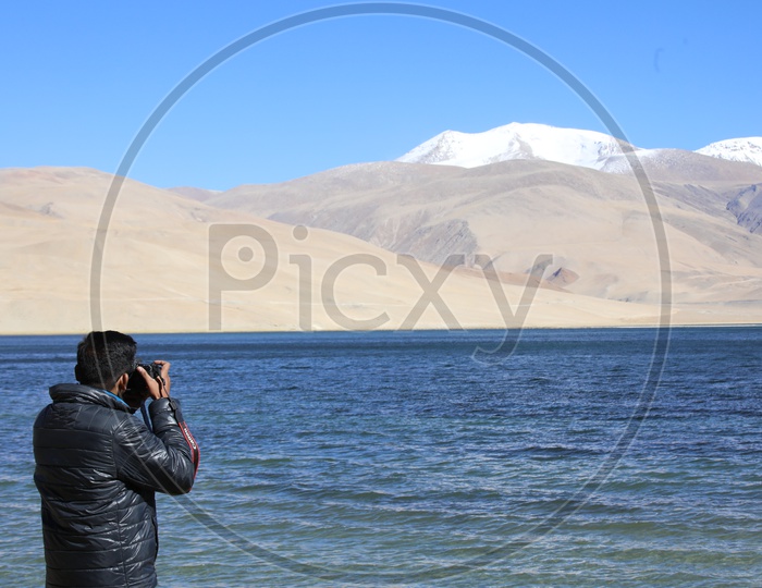 Photographer capturing Mountains of Leh with TsoMoriri Lake