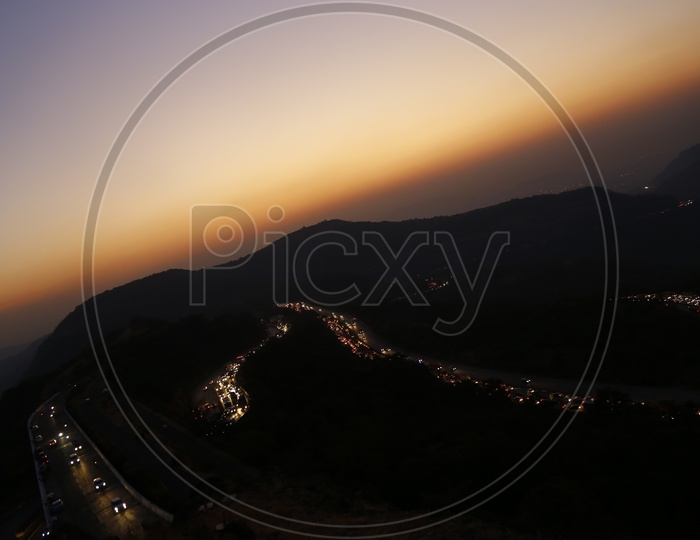 A Beautiful  Shot Of a Bend In Ghat  Roads with Vehicle to hill Stations of  Lonavala at  Night Time