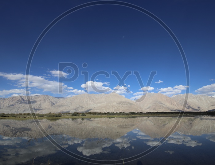 Beautiful Landscape of Snow Capped Mountains of Leh with water reflection