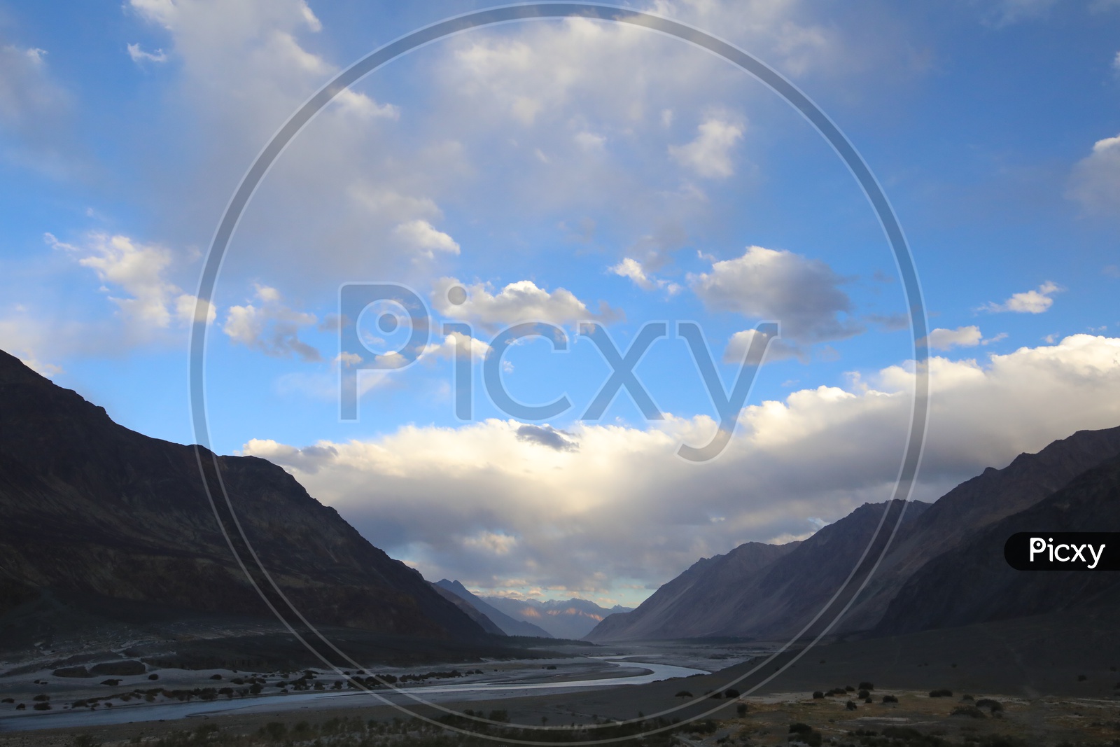 Beautiful Landscape of Snow Capped Mountains of Leh with clouds in the sky