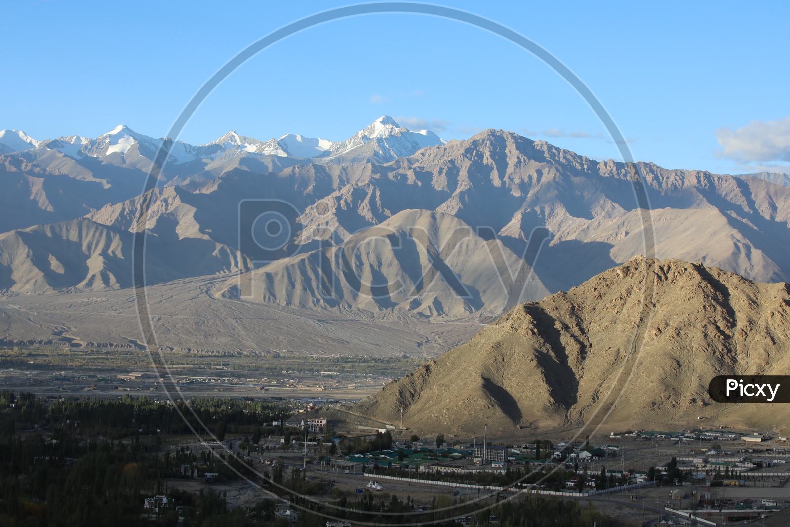 Beautiful Landscape of Snow Capped Mountains of Leh with Village in the foreground