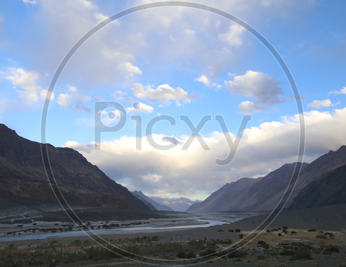 Beautiful Landscape of Snow Capped Mountains of Leh with clouds in the sky