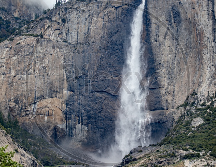 A Composition Shot Of a water Fall With Mountains and Sky