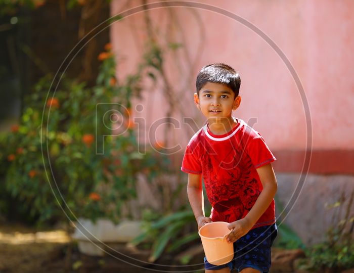 Indian Child Playing with Water