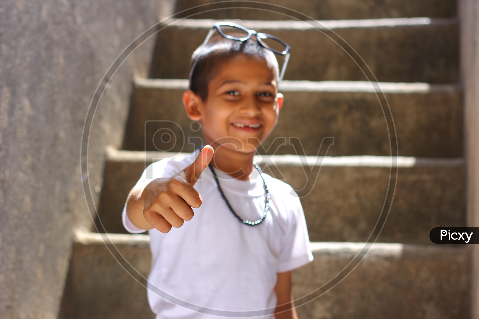 Indian Child showing Thump up or Indian Kid