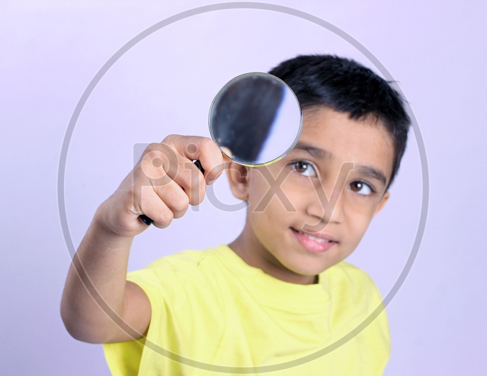 Indian Child Holding Magnifying Glass or Indian Kid