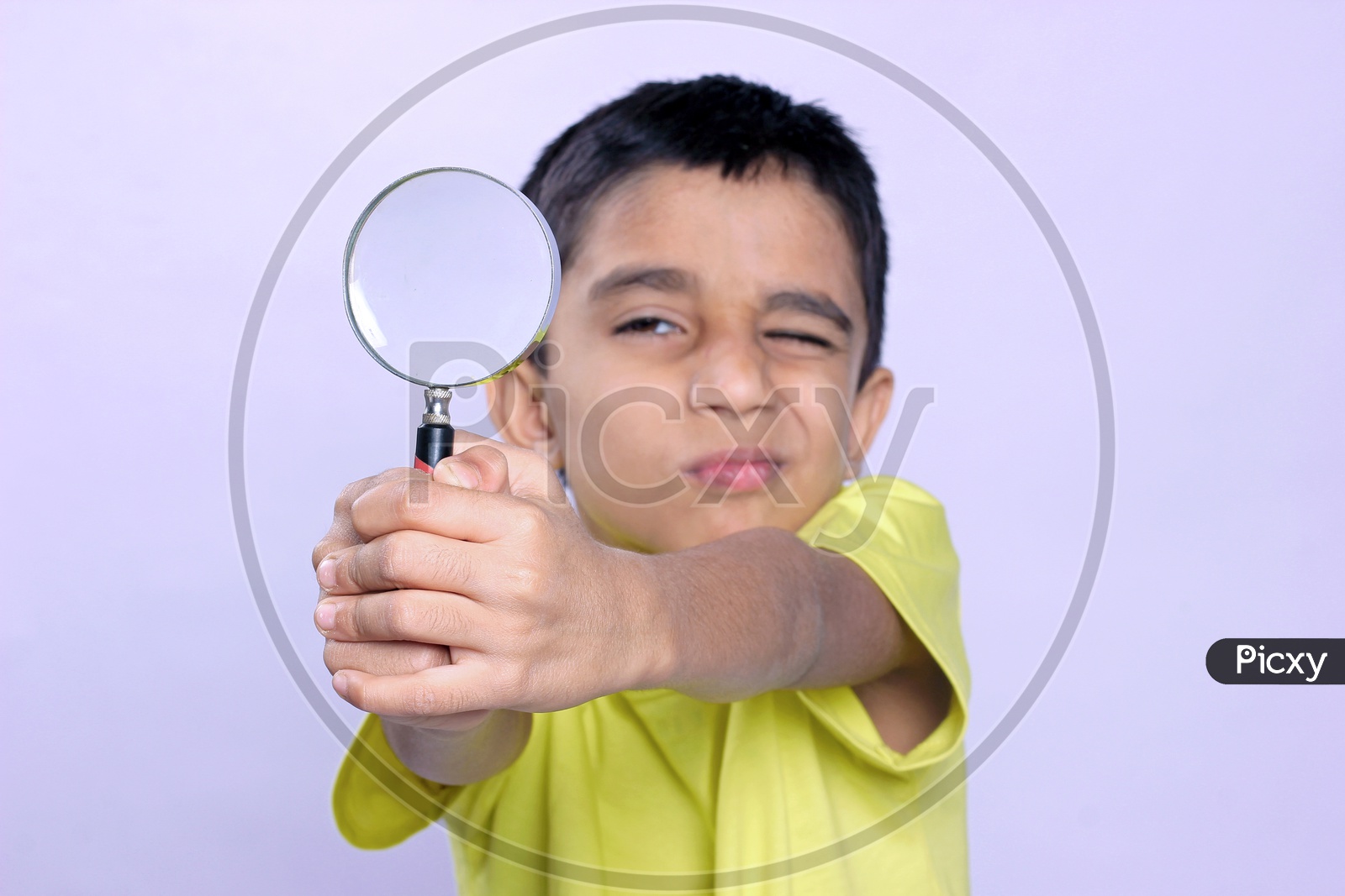 Indian Child holding Magnifying Glass in Hand