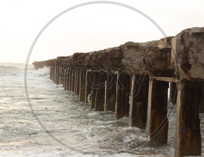 A Pier on a Shore Of a Sea With Pillars Forming a Pattern