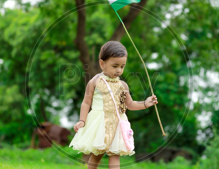 cute little kid having indian flag in hand  / kids portrait