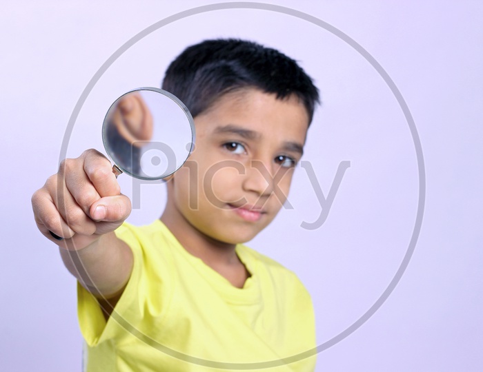 Indian Child Holding Magnifying Glass in Hand