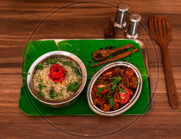 Veg Paneer Fried Rice  and Gobi Manchurian Beautifully Presented Over a Plate Coposition Shot on a Wooden BackGround
