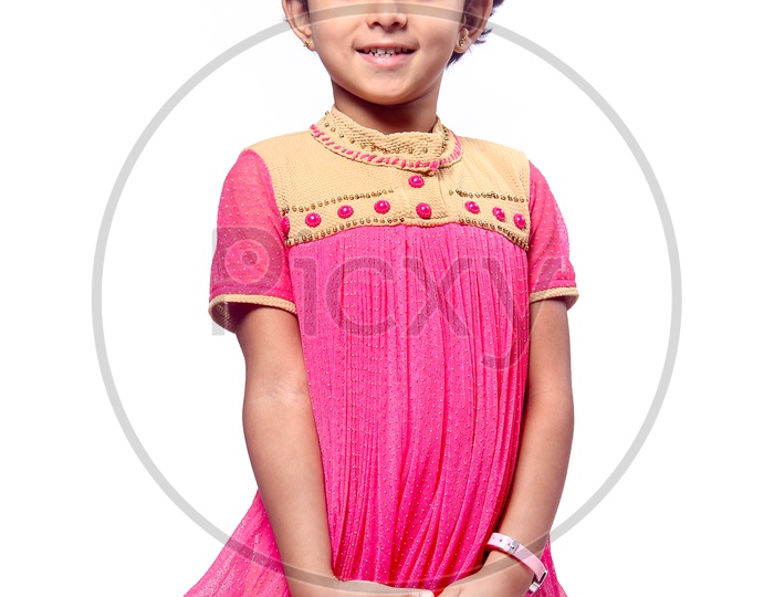 Girl dressed up in pink frock with a flower hair band