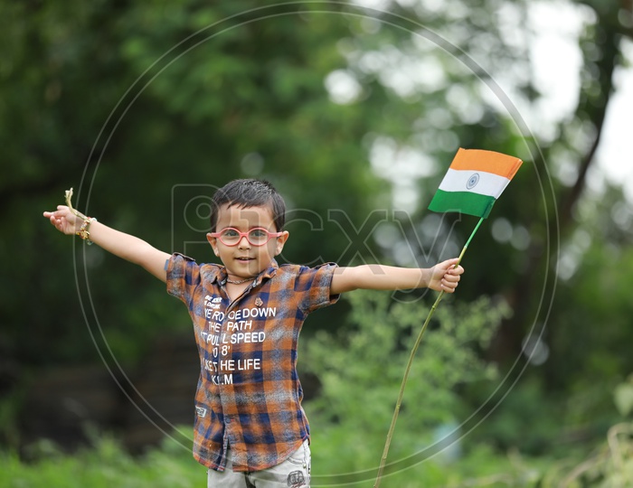 cute little kid having indian flag in hand  / indian flag / nation india