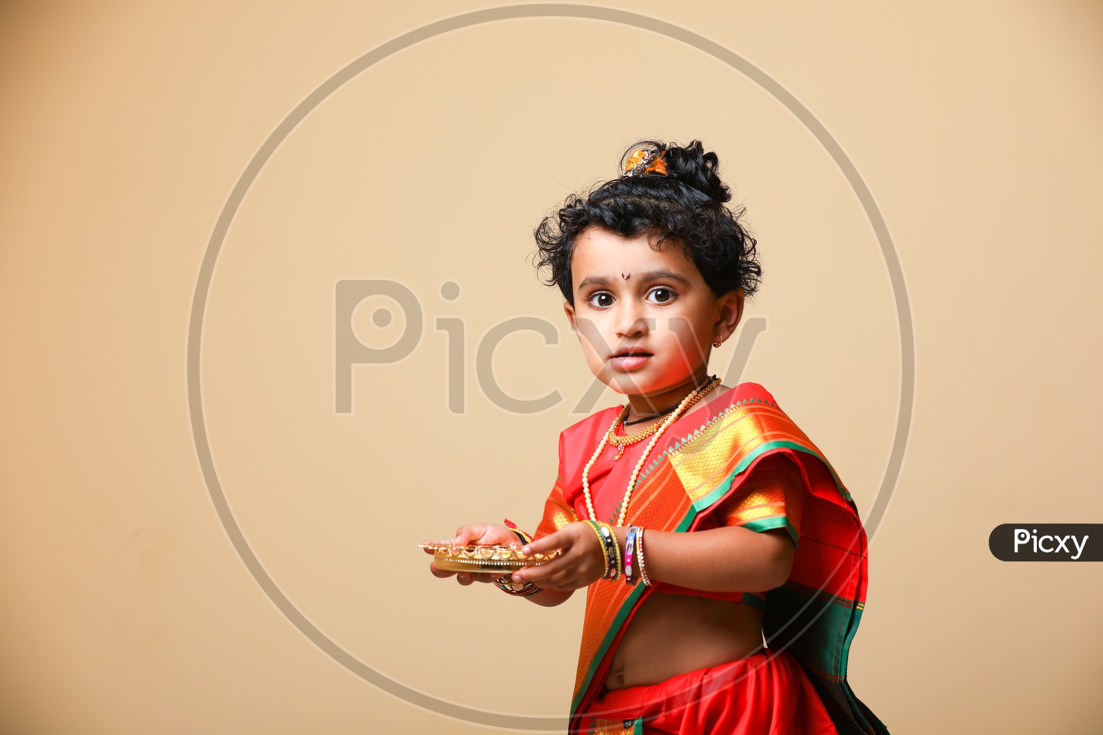 Indian girl dressed in Saree as a Marathi Woman Rani and taking Aarathi/Arati