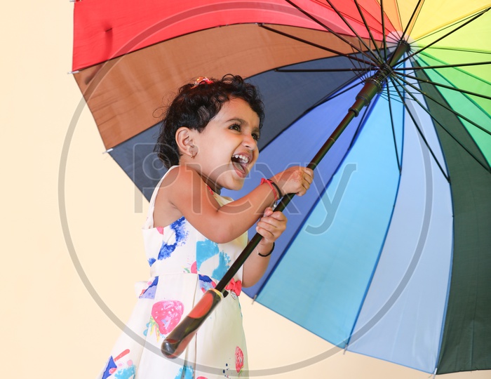 Indian Girl Child Posing with Rainbow Umbrella