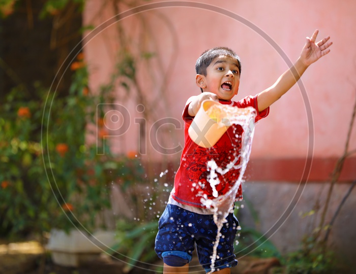 Indian Child Playing with Water