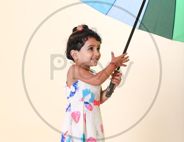 Indian Girl Child Posing with Rainbow Umbrella