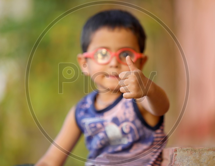 Indian Child on Eyeglass Showing Thump up