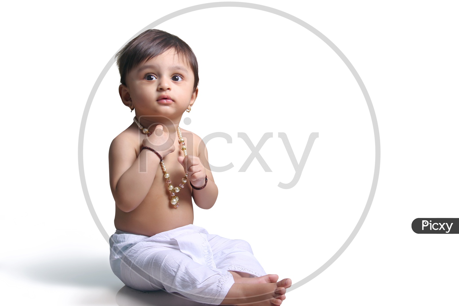 Baby girl dressed up like little lord krishna