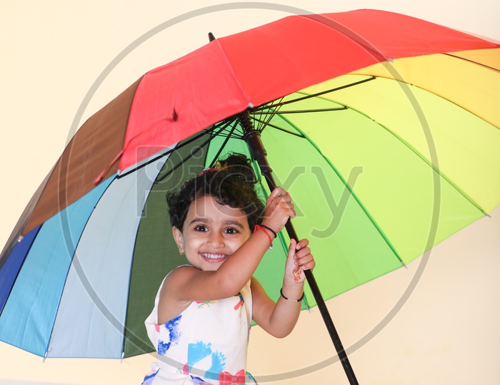 Smiling Indian Girl Child with Umbrella