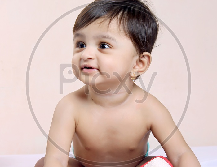 Cute baby girl poses for a camera