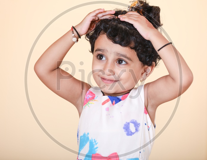 A cute stylish little Indian girl with long hair and hands in pocket  wearing stylish jean and tops Stock Photo - Alamy