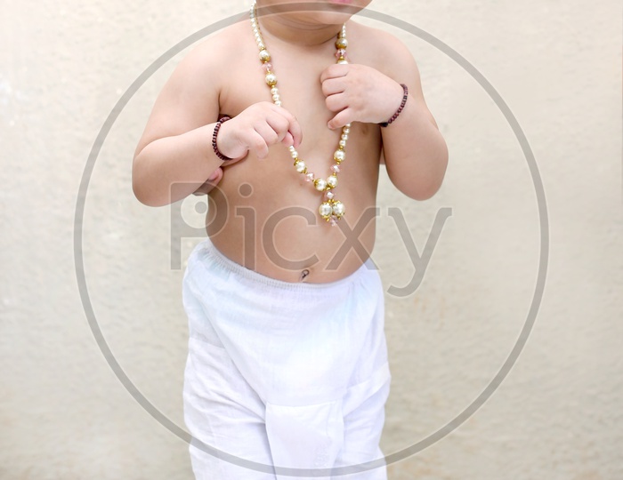 Baby girl dressed up like little lord Krishna