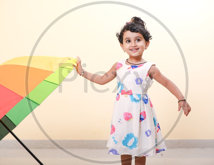 Indian Girl Child with Umbrella and smiling face