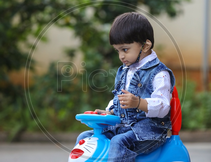 Indian Child or Indian Kid Playing with Toy Car