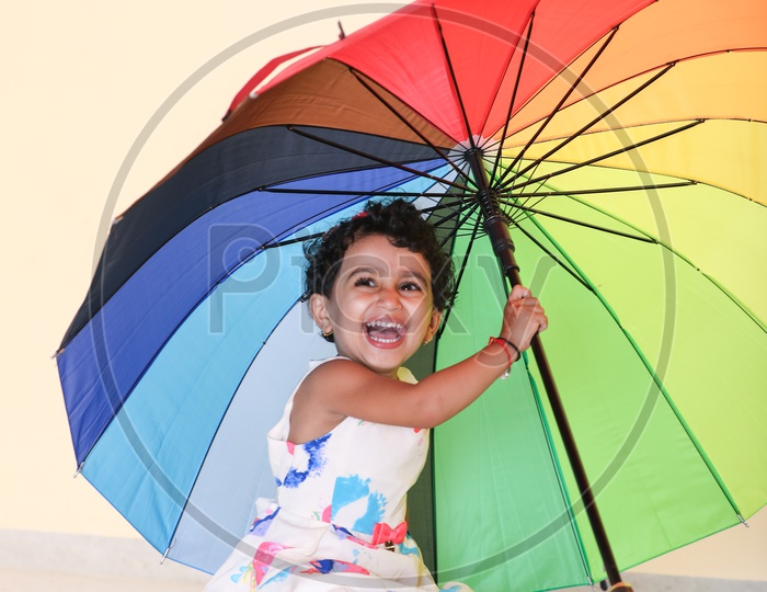 Smiling Indian Girl Child with Umbrella