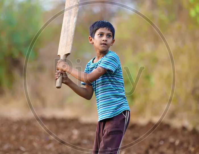 Rural Indian Child Playing Cricket