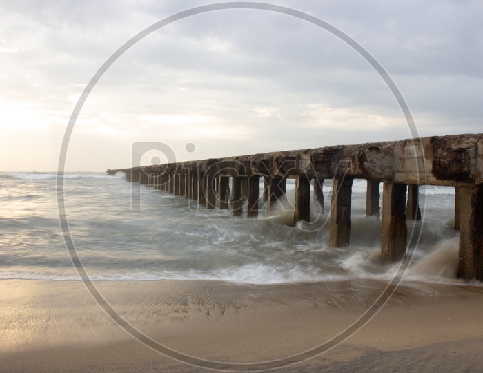 A Pier on a Shore Of a Sea With Pillars Forming a Pattern