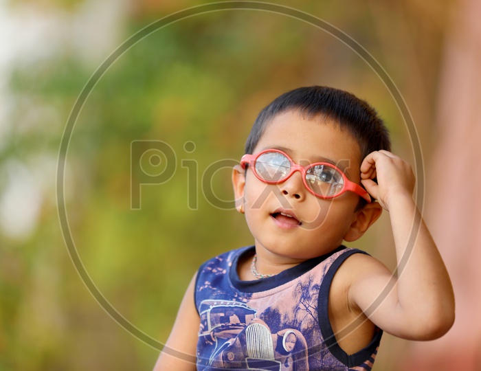 Indian Child with spectacles thinking..