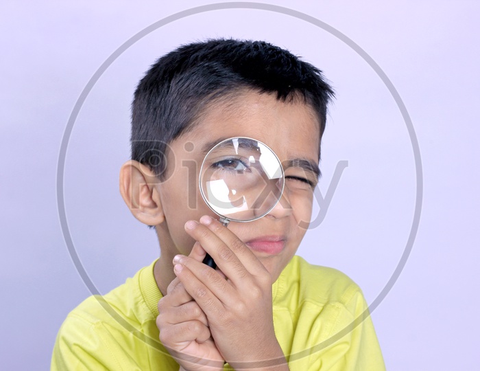 Indian Child Holding Magnifying Glass