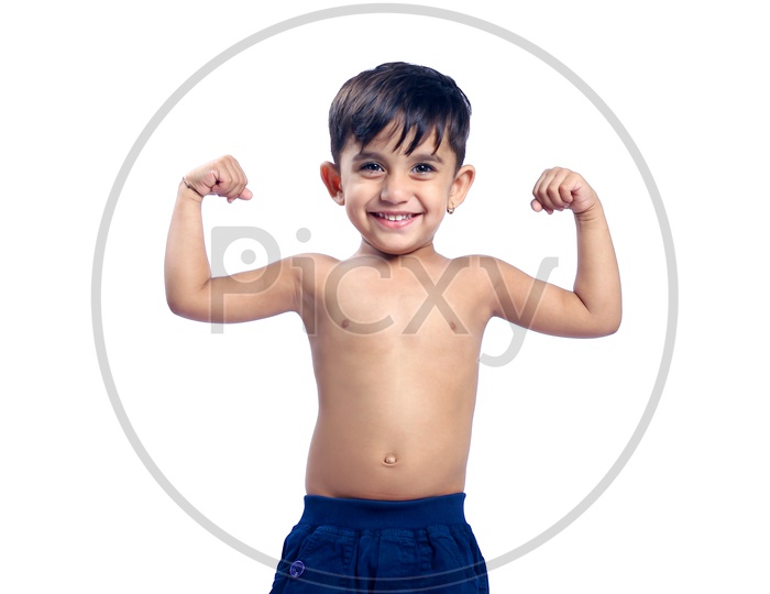 Smiling Indian Child / Kid  showing Muscles with a white background