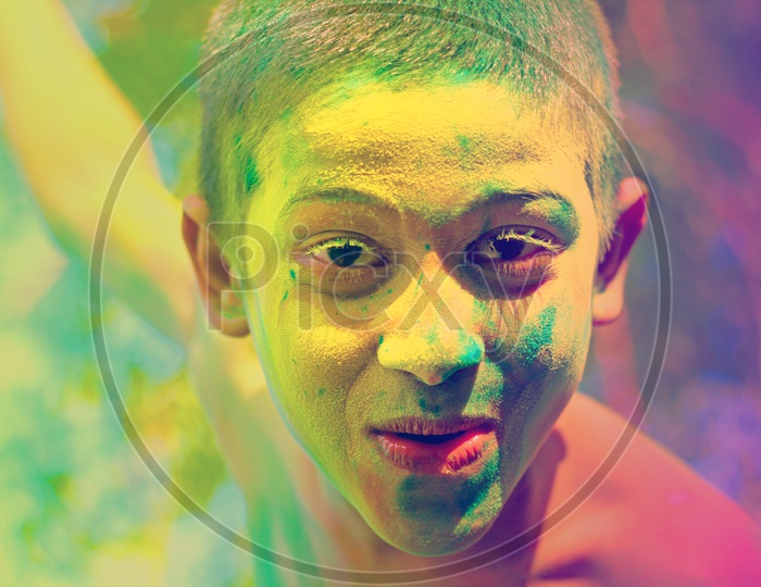 Boy with Holi colours/colors on face close up