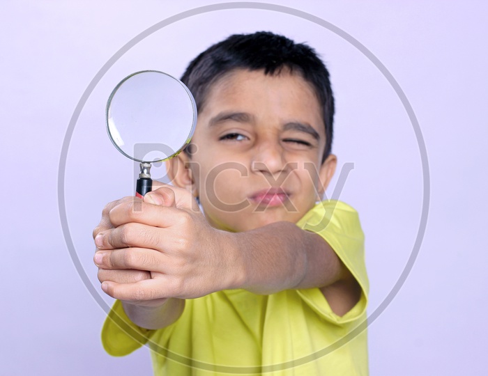 Indian Child holding Magnifying Glass in Hand