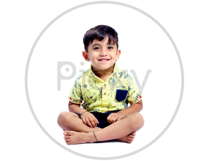cute little kid with happy face , facing towards the camera
