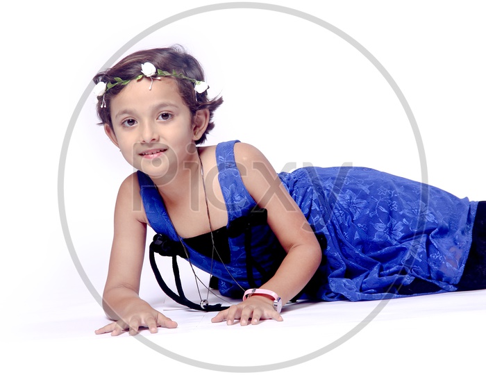 Girl dressed up in blue frock with a flower hair band