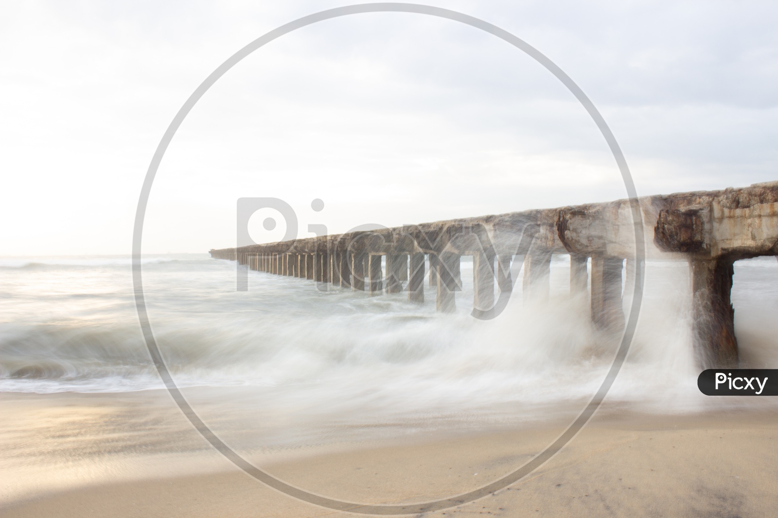 Long Exposure Shot of a Pier and Sea Waves  From Shore