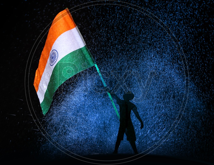 A kid holding Indian National flag with blue and black background