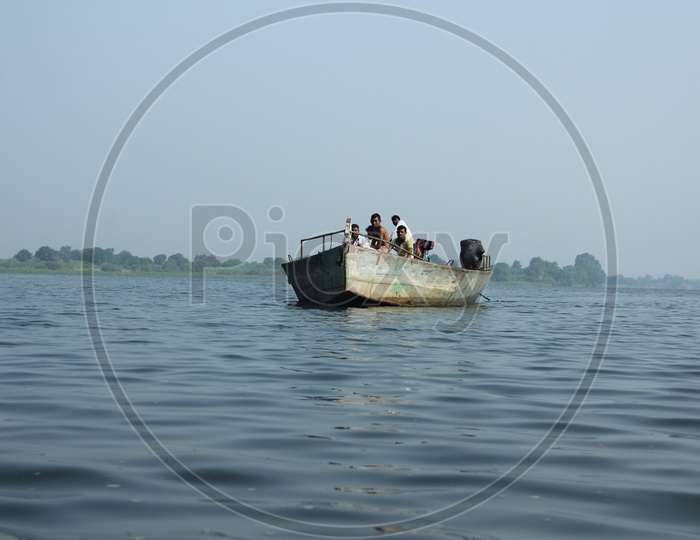 people traveling across the river in a boat