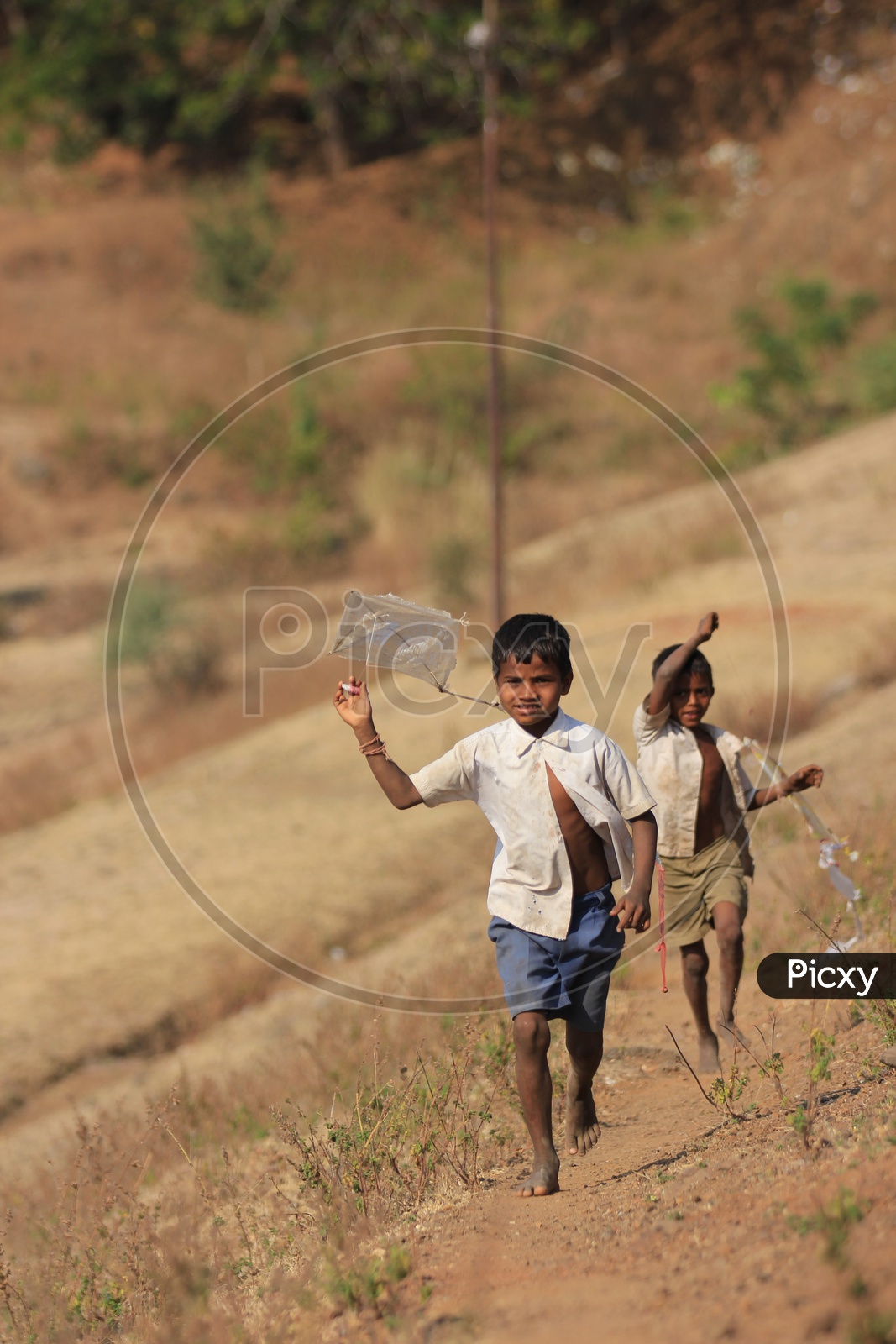 Two kids having fun by flying Kites