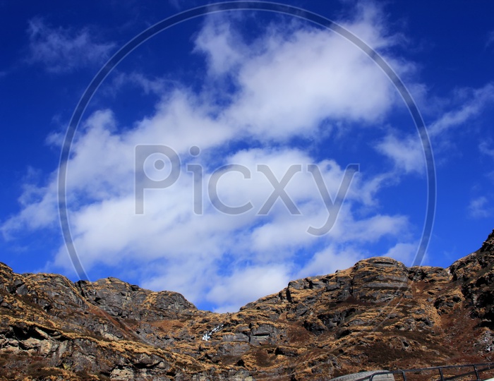 Terrains or rocky hills with blue sky and white clouds