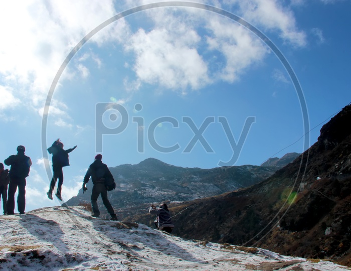 People enjoying trekking on mountains covered with snow