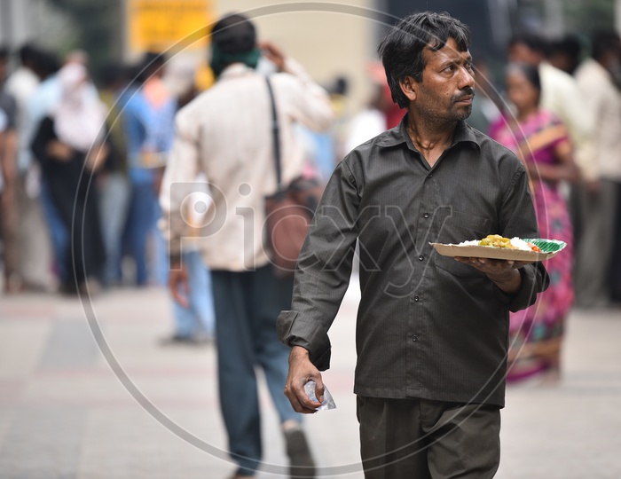 A Man Carrying His meal from GHMC Annapurna Meal Counter.