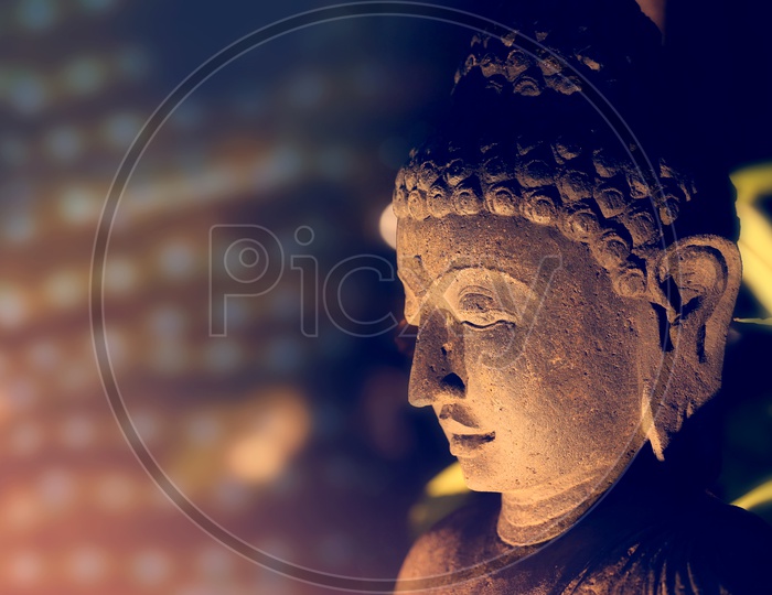Face of the Buddha lit by a soft light