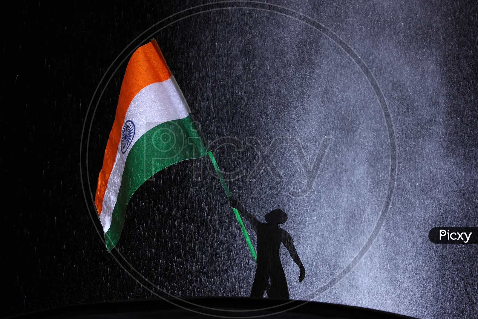 A kid holding Indian National flag with dark blackground